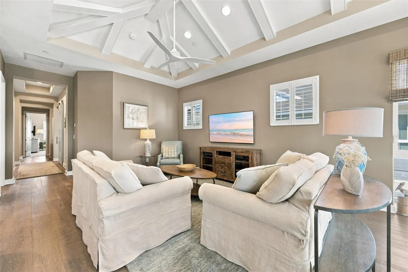 Enjoy peaceful Sapphire Lake views from this beautifully appointed home, featuring an open-concept floor plan, soaring vaulted ceilings, and Mohawk engineered hardwood flooring.