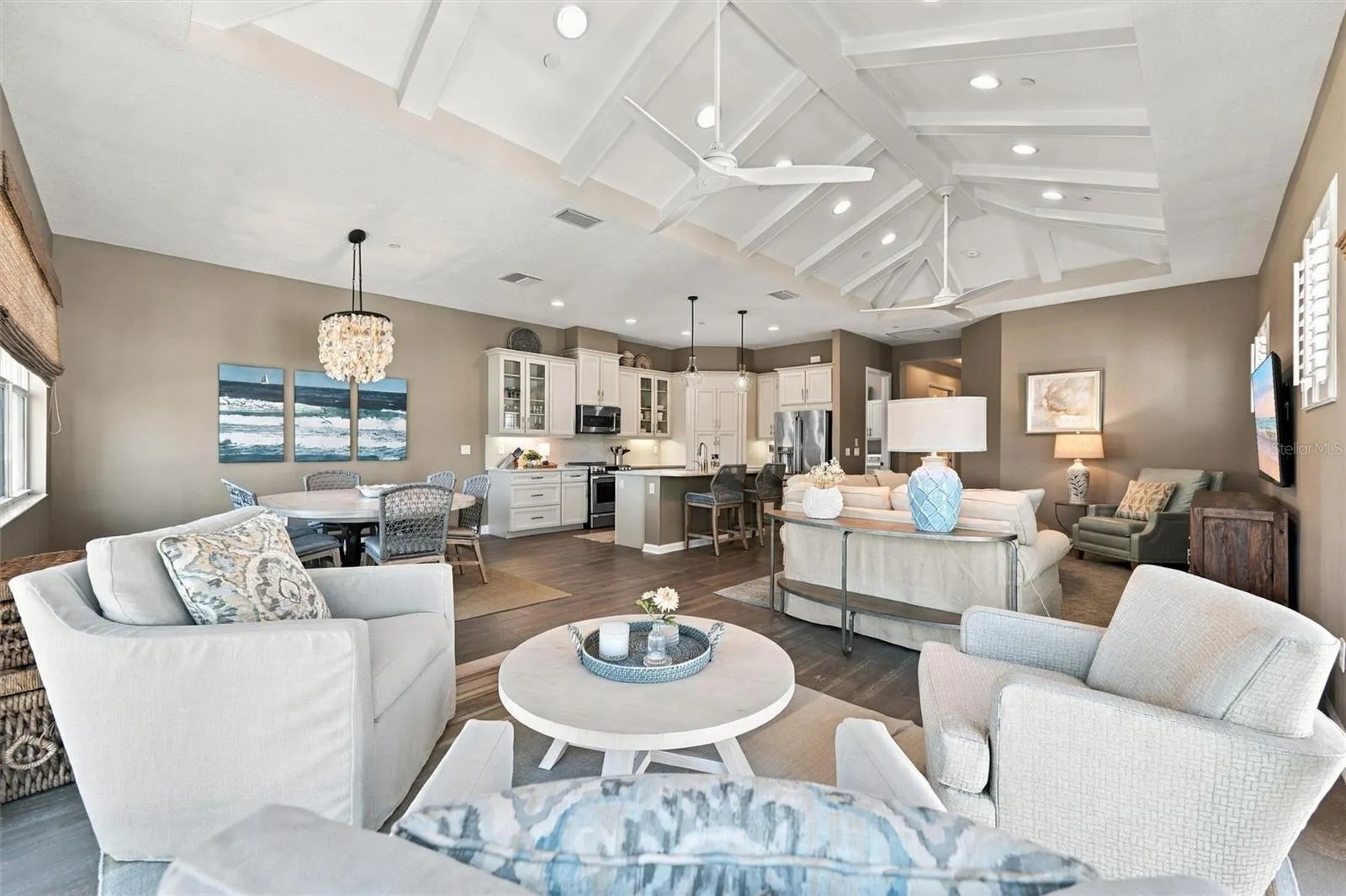 Enjoy peaceful Sapphire Lake views from this beautifully appointed home, featuring an open-concept floor plan, soaring vaulted ceilings, and Mohawk engineered hardwood flooring.