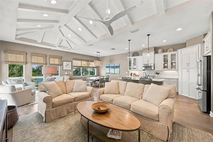 Enjoy peaceful Sapphire Lake views from this beautifully appointed home, featuring an open-concept floor plan, soaring vaulted ceilings, and Mohawk engineered hardwood flooring.