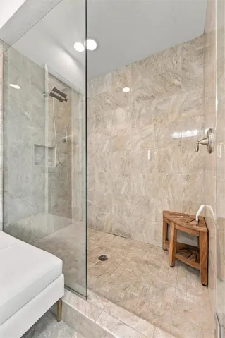 The spacious primary ensuite features dual vanities, a large walk-in shower, a private water closet, and convenient access to one of the suite’s two walk-in closets.