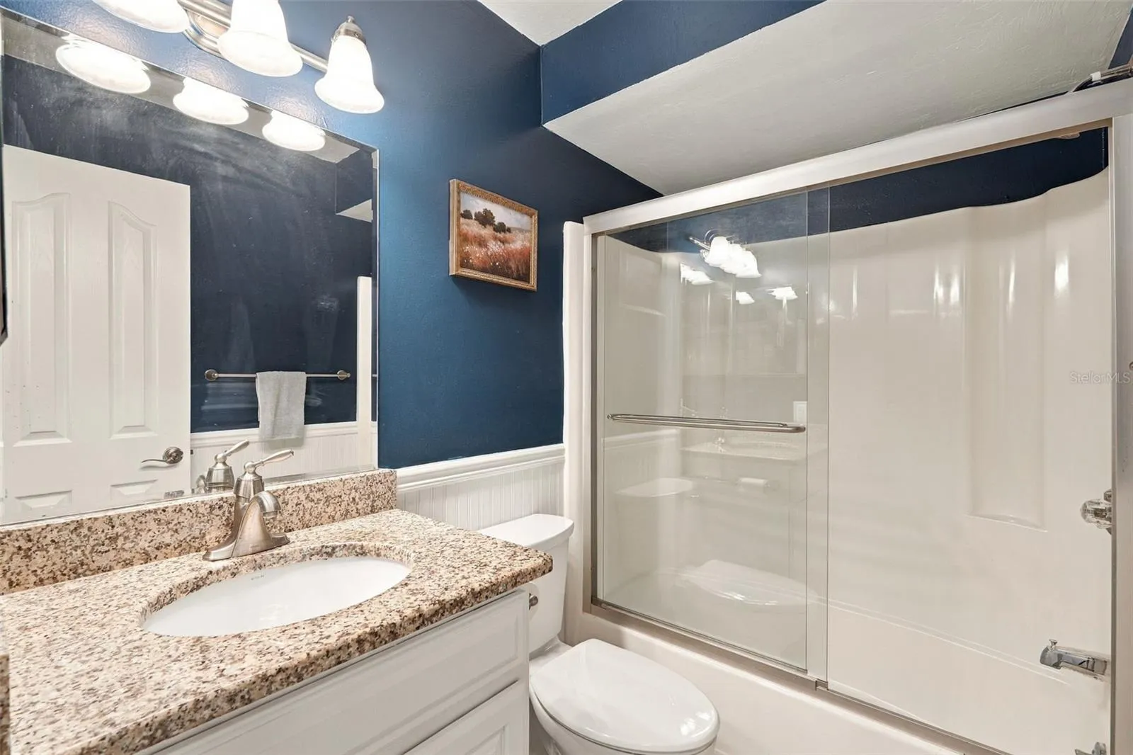 Guest Bathroom Features Granite Countertops and Tub/Shower Combo