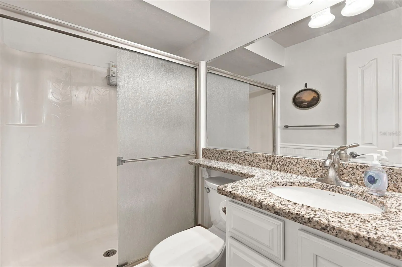 Spacious Walk-In Shower with Granite Top Vanity
