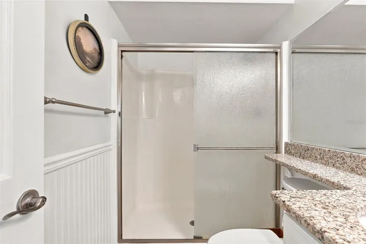 Spacious Walk-In Shower with Granite Top Vanity
