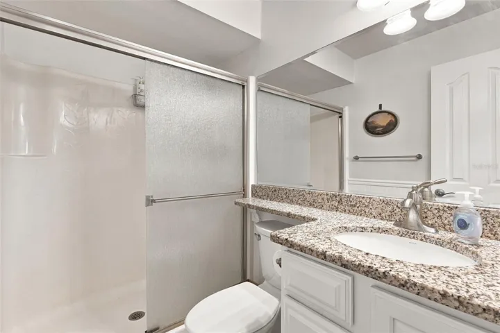 Spacious Walk-In Shower with Granite Top Vanity