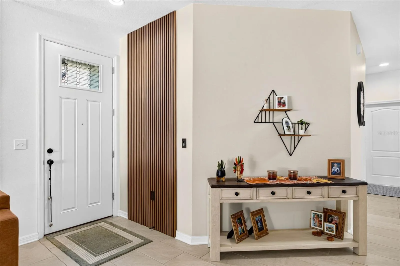 Entryway has paneling accent wall welcoming you home!