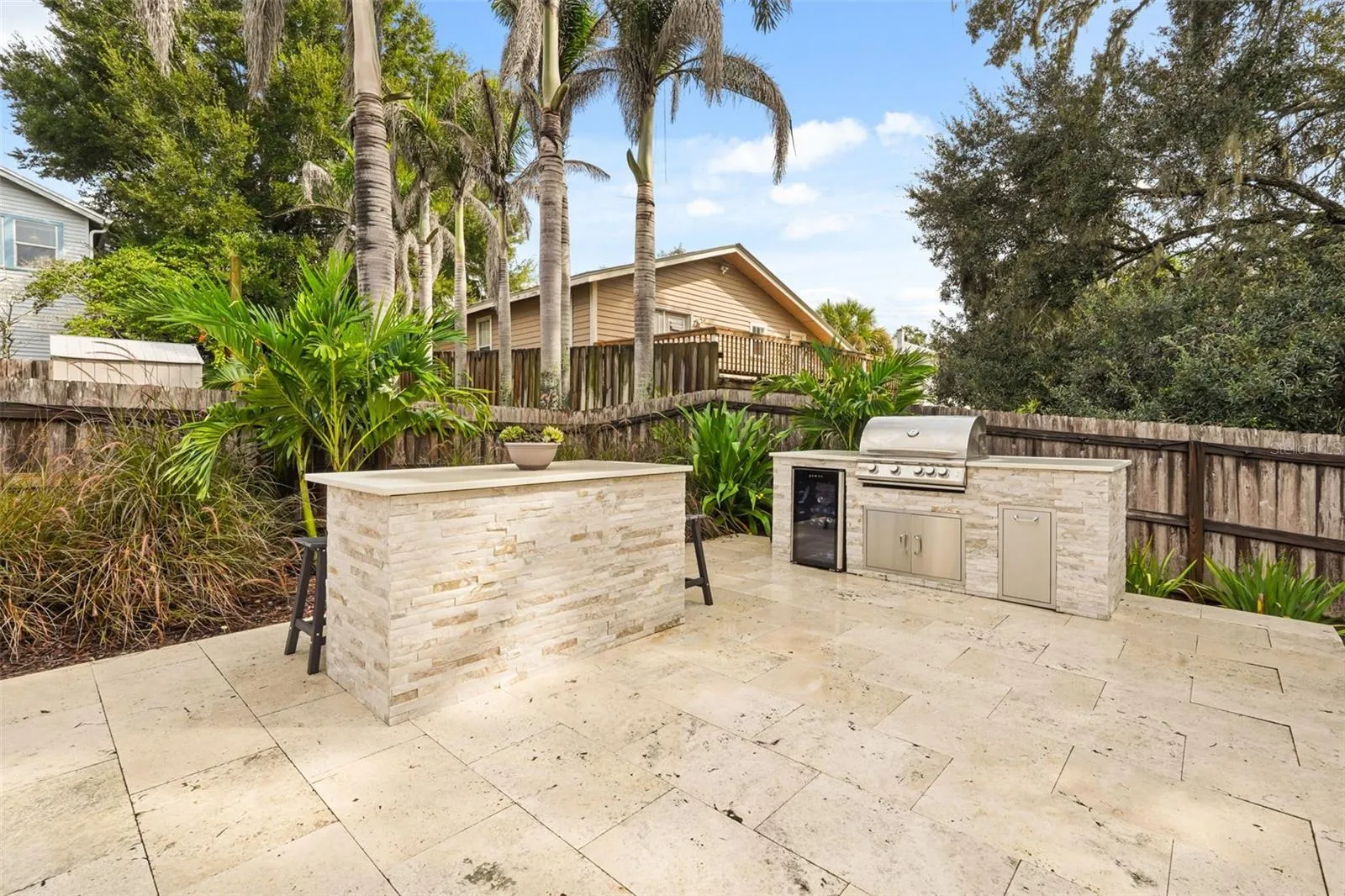 Outdoor kitchen with built-in grill and beverage refrigerator