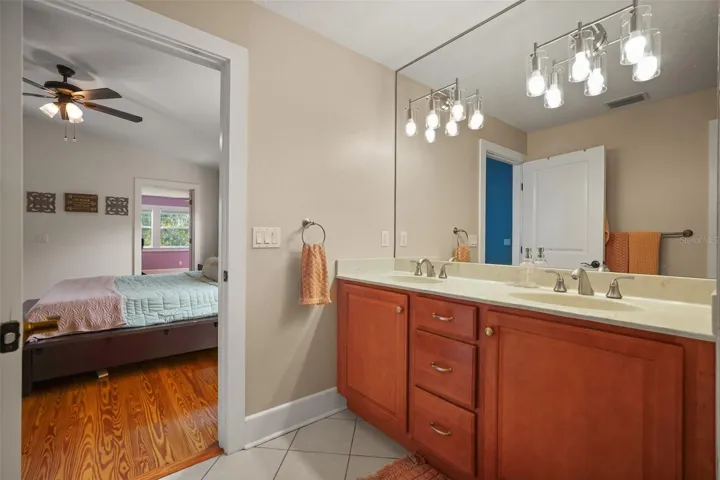 Primary bathroom dual vanity with view into the primary bedroom