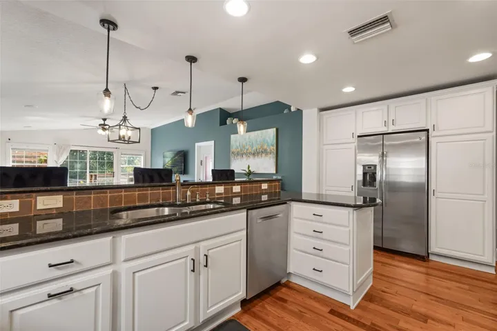 Kitchen sink, dishwasher, and side-by-side refrigerator