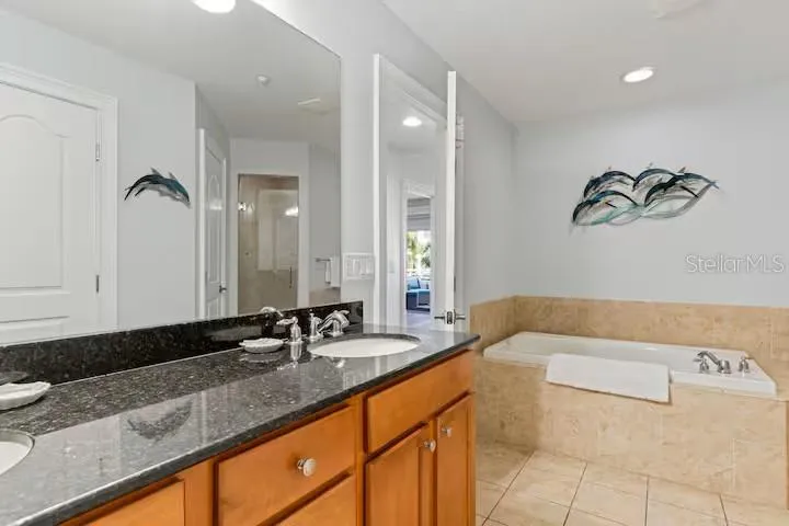 Primary ensiut bathroom with large soaking tub, walk in shower, and private water closet.