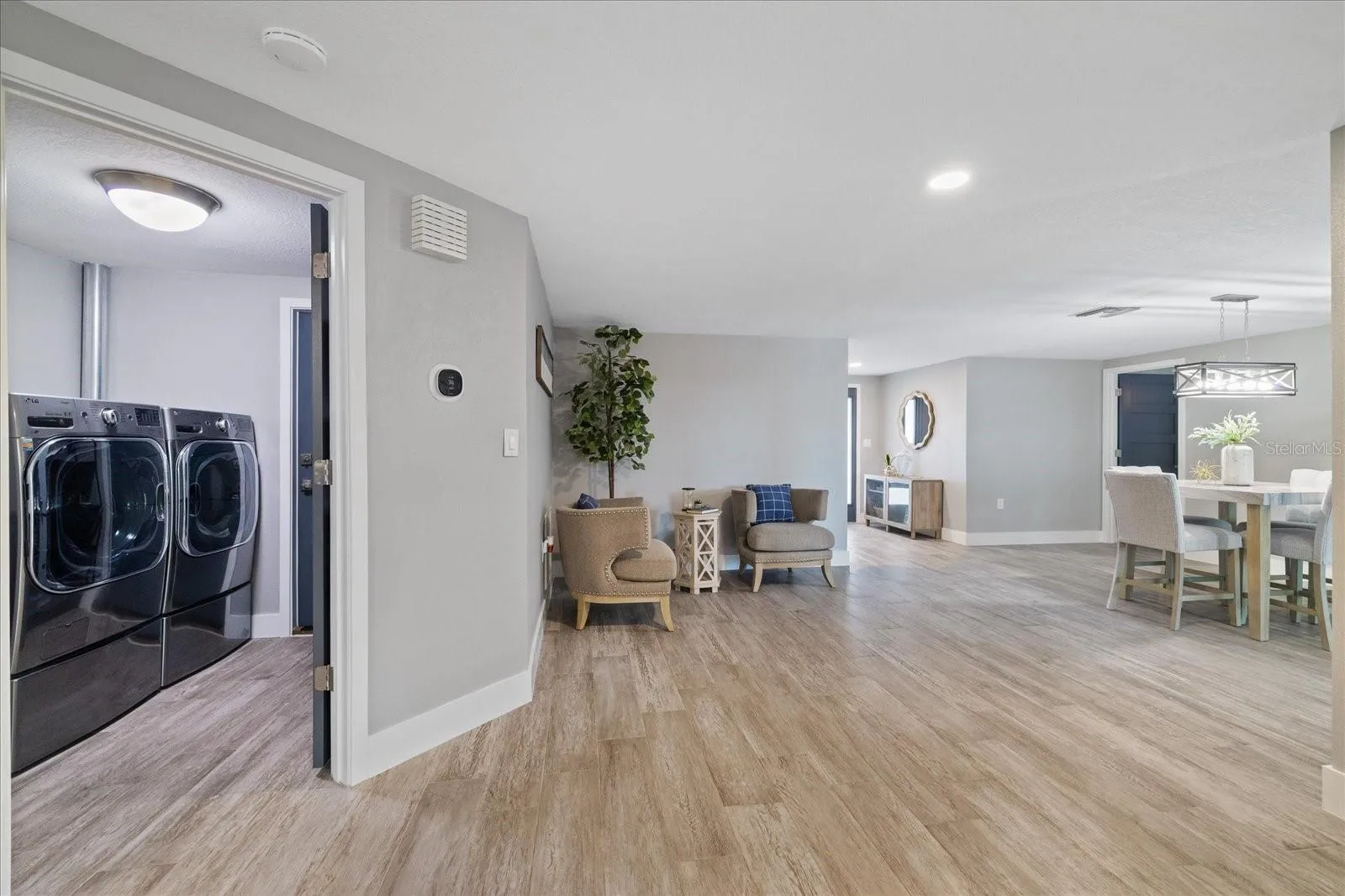 Laundry room centrally located and climate controlled with garage access door.