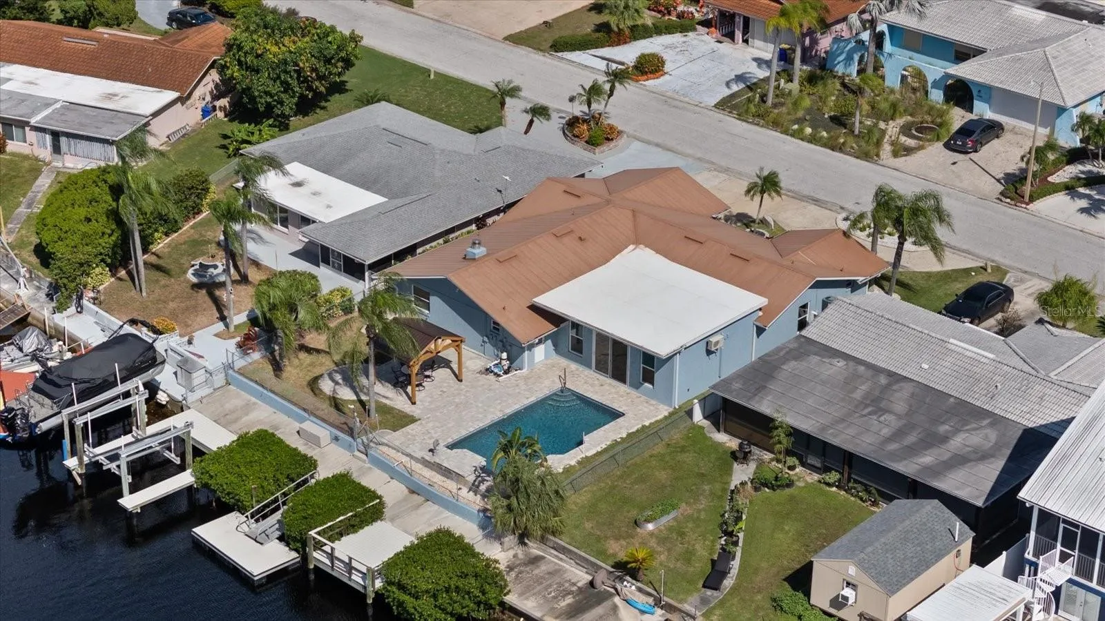 Aerial of home showing waterfall pool, gazebo, boat lift, floating dock and stationary dock