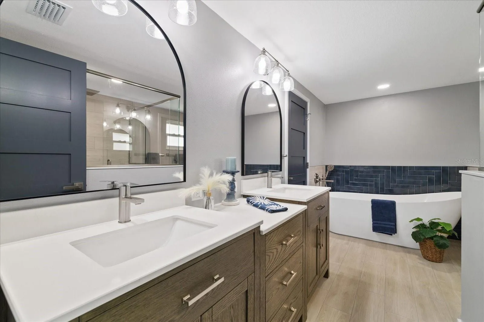 Primary ensuite with double vanity sinks and soaking tub