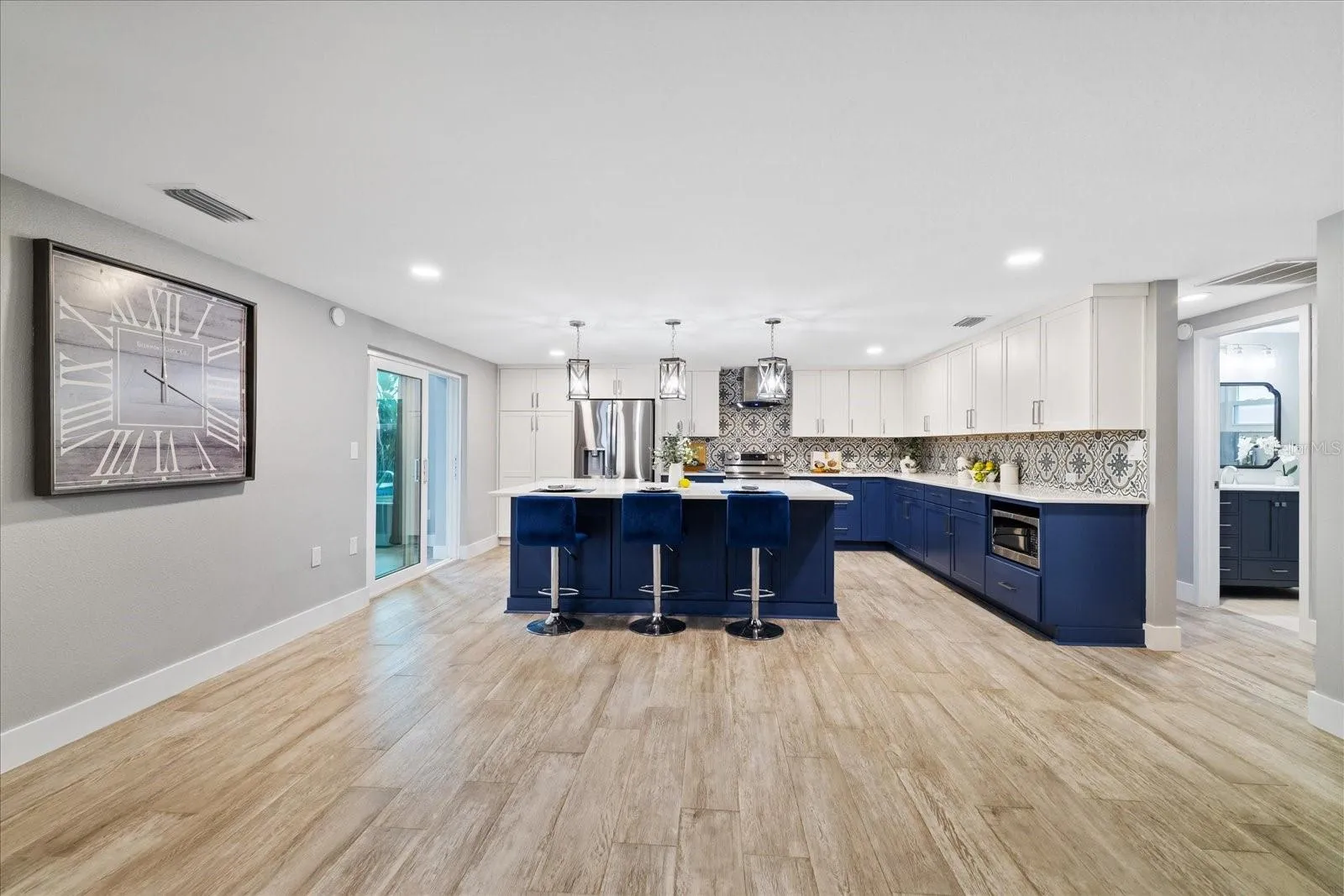kitchen showing door to guest bedrooms and full bath and sliders to family room