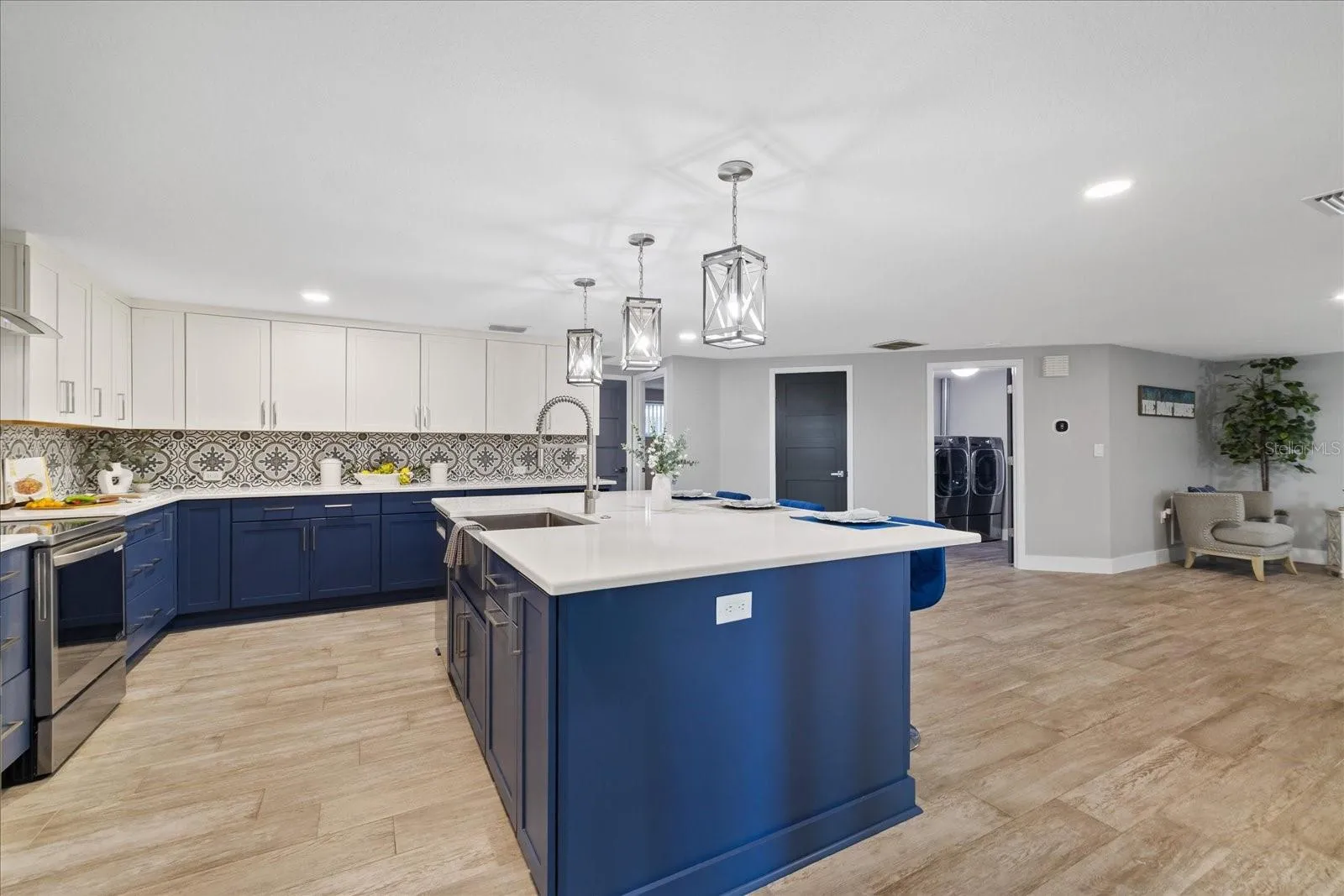 Large island sink in kitchen with breakfast bar