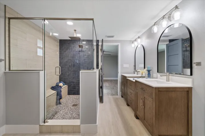 Large walk-in shower with ledge in primary