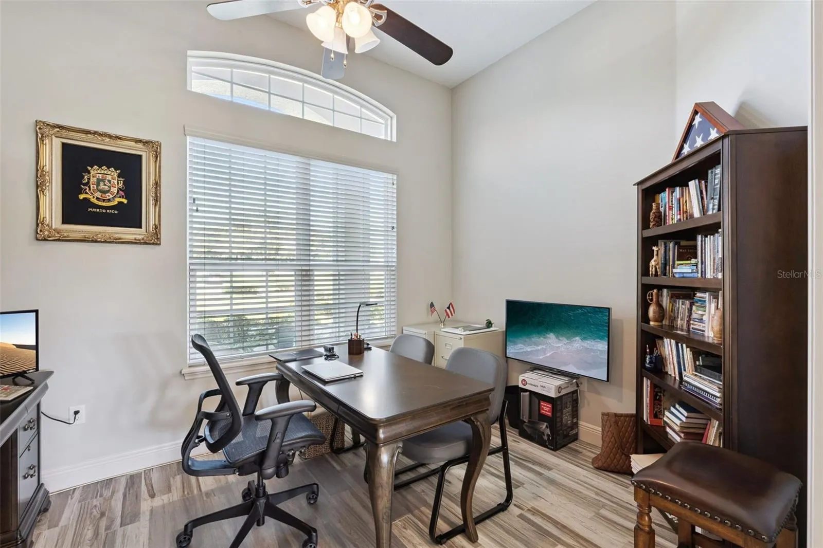 Office located near front door for easy access and wood look tile floors