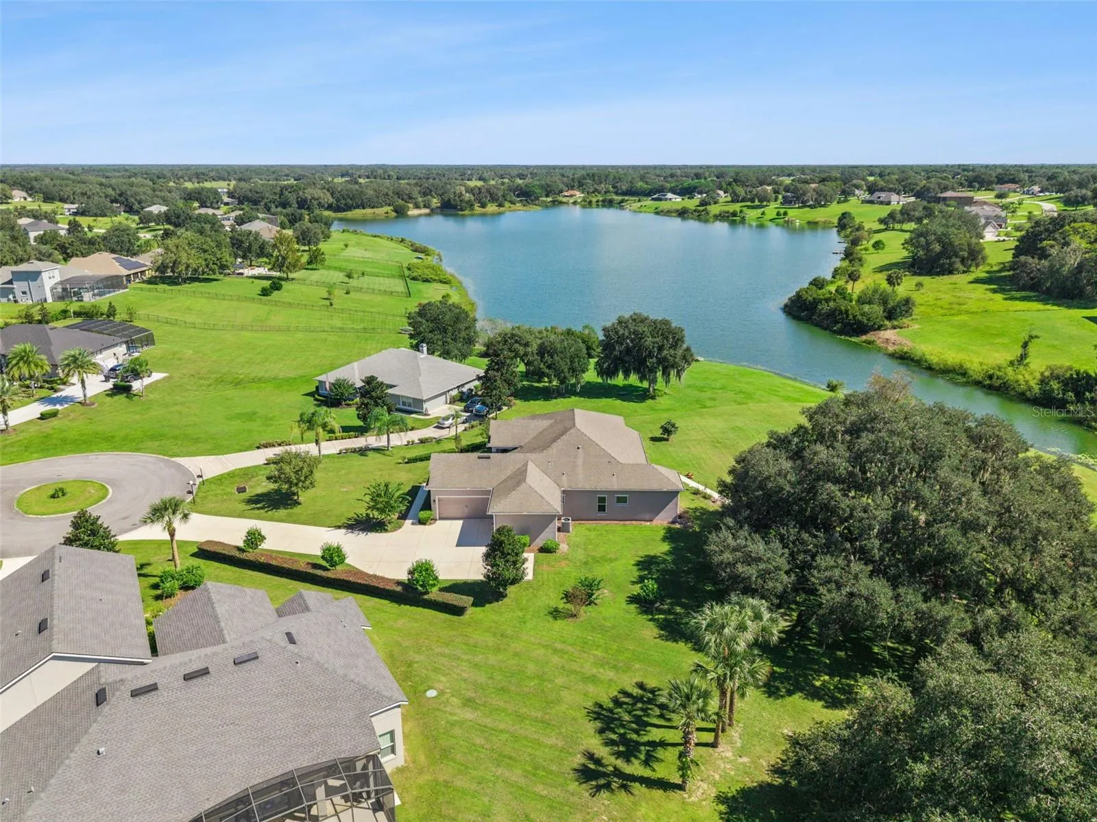 This property features a long, private driveway leading to an expansive estate.