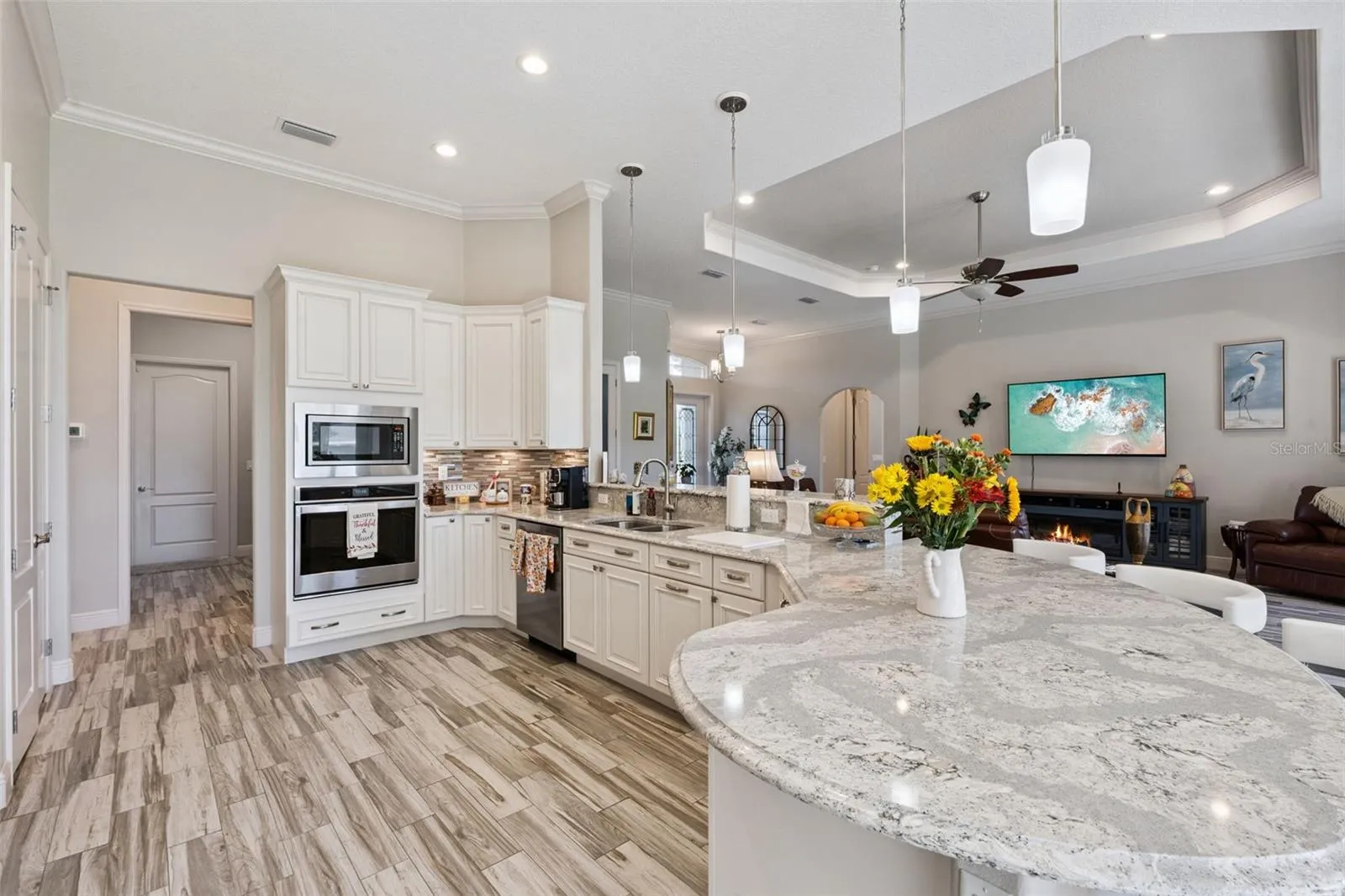 Enjoy family gatherings in the spacious kitchen, featuring a beautiful curved quartz island with comfortable seating for 8 or more.