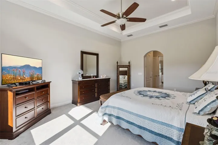 Primary suite featuring a spacious layout and a direct, open view into the private en suite bathroom.