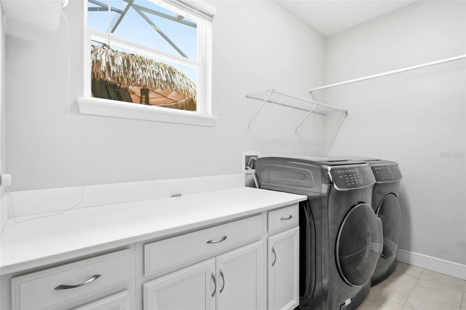 Laundry room features cabinet and counter space along with a washer and dryer