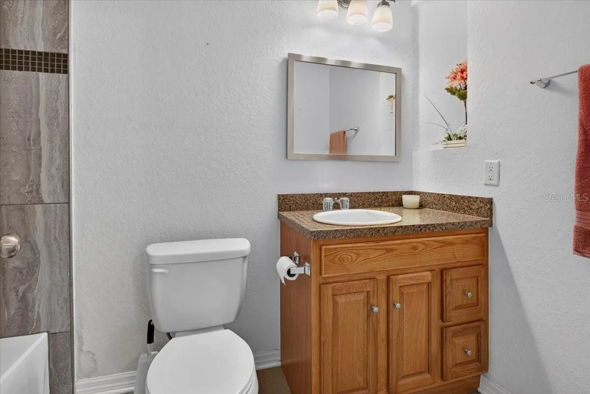 Primary bathroom with tub and tile shower