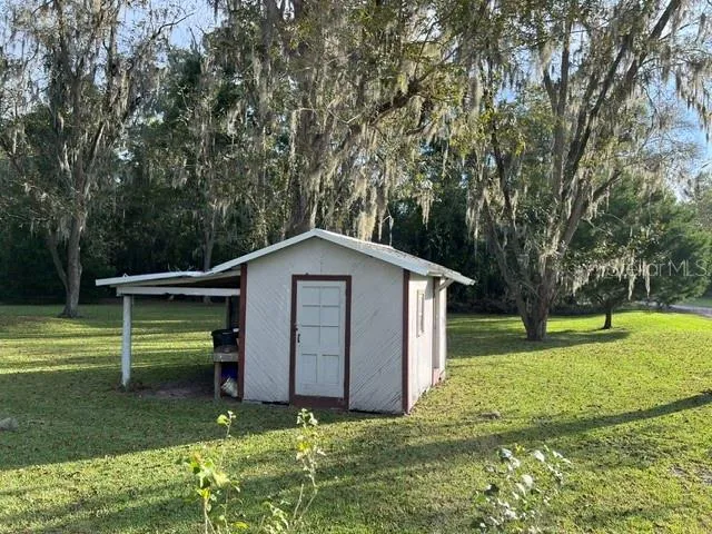 Plus a generous storage building with extra covered space on the side!