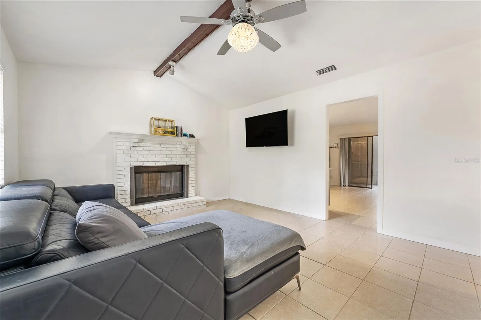 Living room with wood burning fireplace.