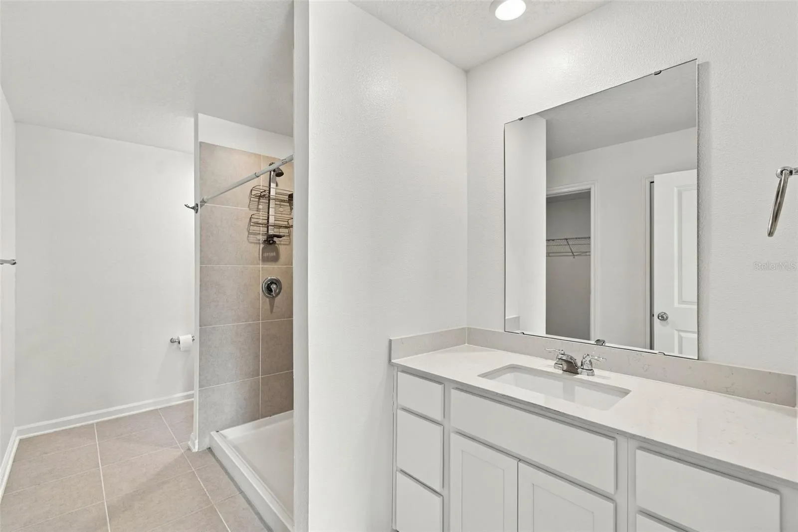 The private owner’s suite is tucked away at the back of the home and features an en-suite bathroom with dual sinks, a walk-in shower, and a generous walk-in closet.