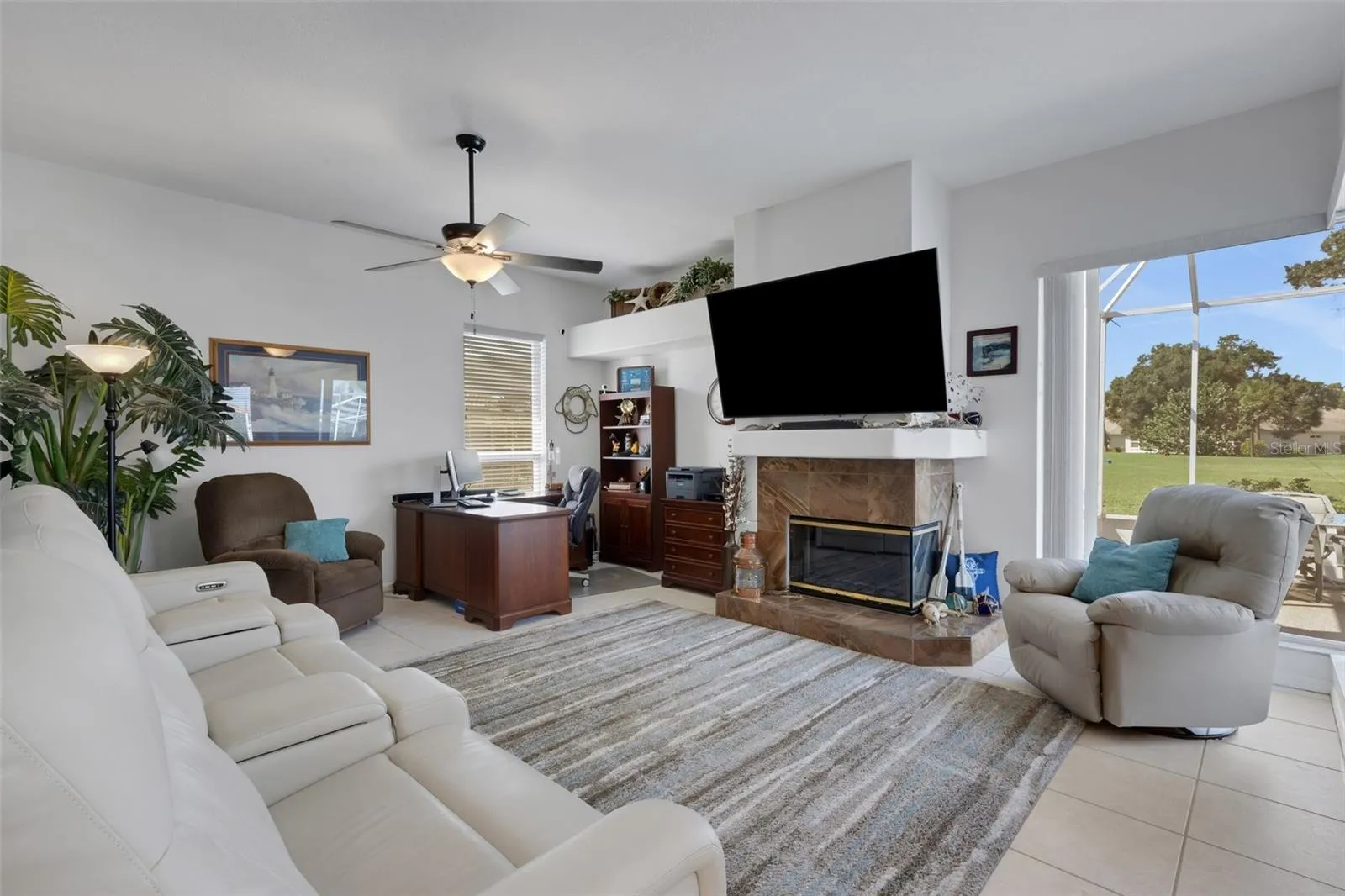 Family room with view of golf course and pool