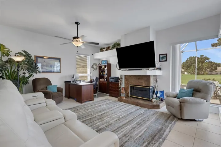 Family room with view of golf course and pool