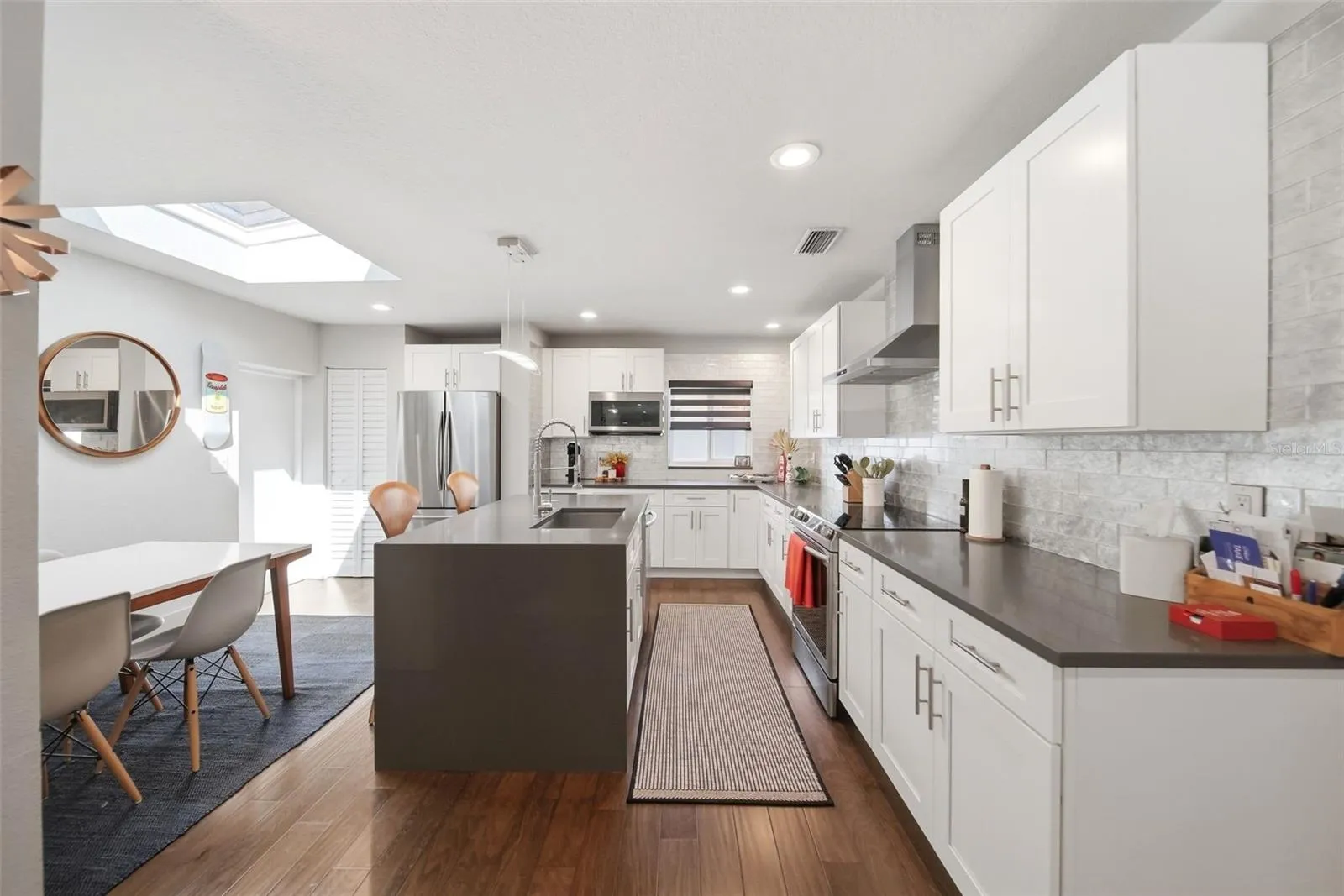 The skylight allows natural light to pour into the dining area and kitchen