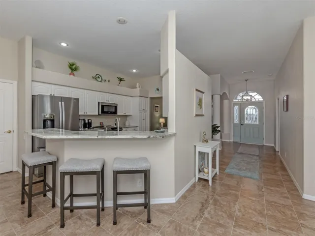 Pull up a chair and stay awhile! This inviting breakfast bar adds a casual touch to the beautifully appointed kitchen, perfect for a quick bite, a cup of coffee, or keeping the cook company!
