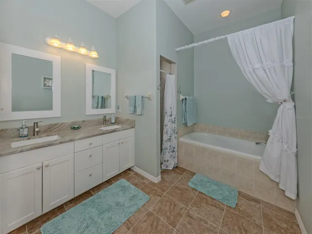 A beautiful blend of comfort and elegance! This spacious primary ensuite features gorgeous granite countertops with dual sinks, a refreshing walk-in shower, a separate soaking tub for those well-deserved moments of relaxation, recessed lighting, and a private water closet. Your own little retreat to refresh, relax, and unwind!