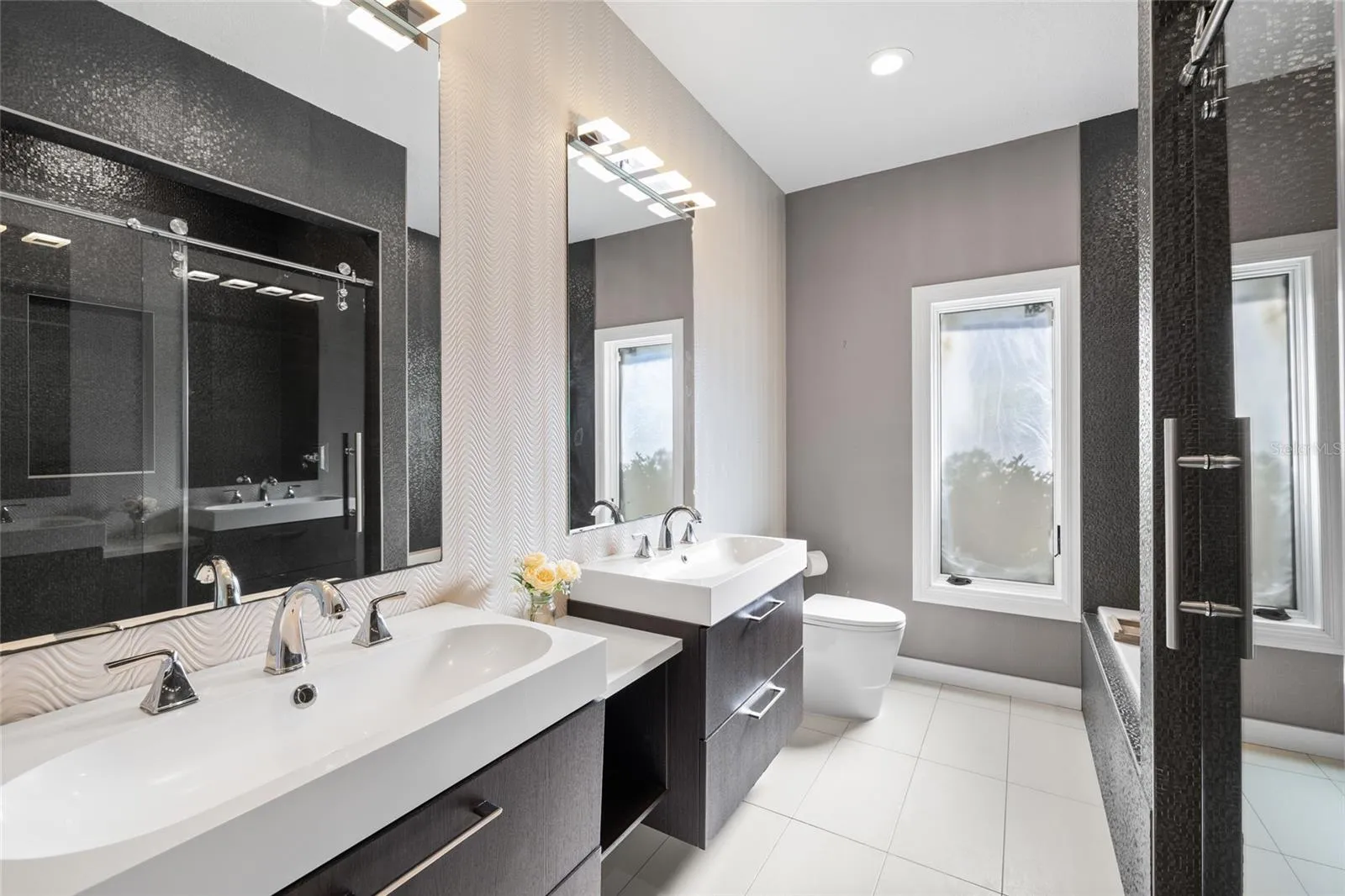 Bathroom 3 with dual vanities, tub and separate shower