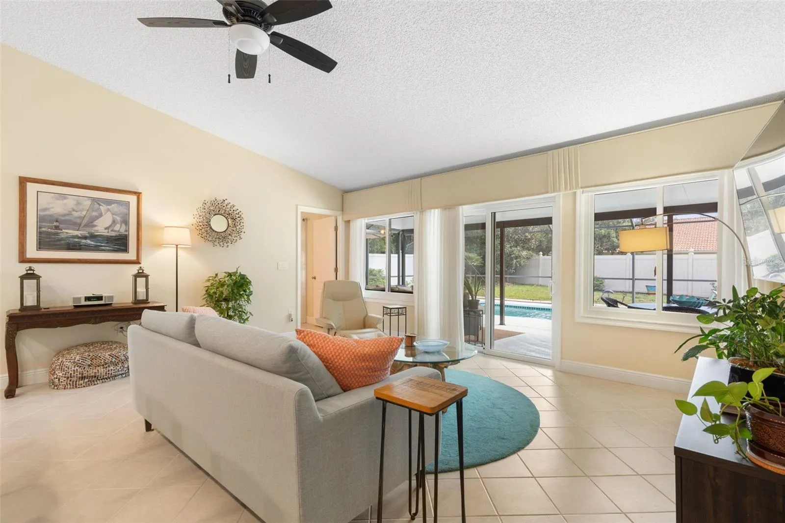 Just a few steps from the sofa, the sparkling pool beckons! Expansive windows and sliding glass doors bring the Florida sunshine indoors, making it easy to slip outside for a refreshing swim whenever the mood strikes.