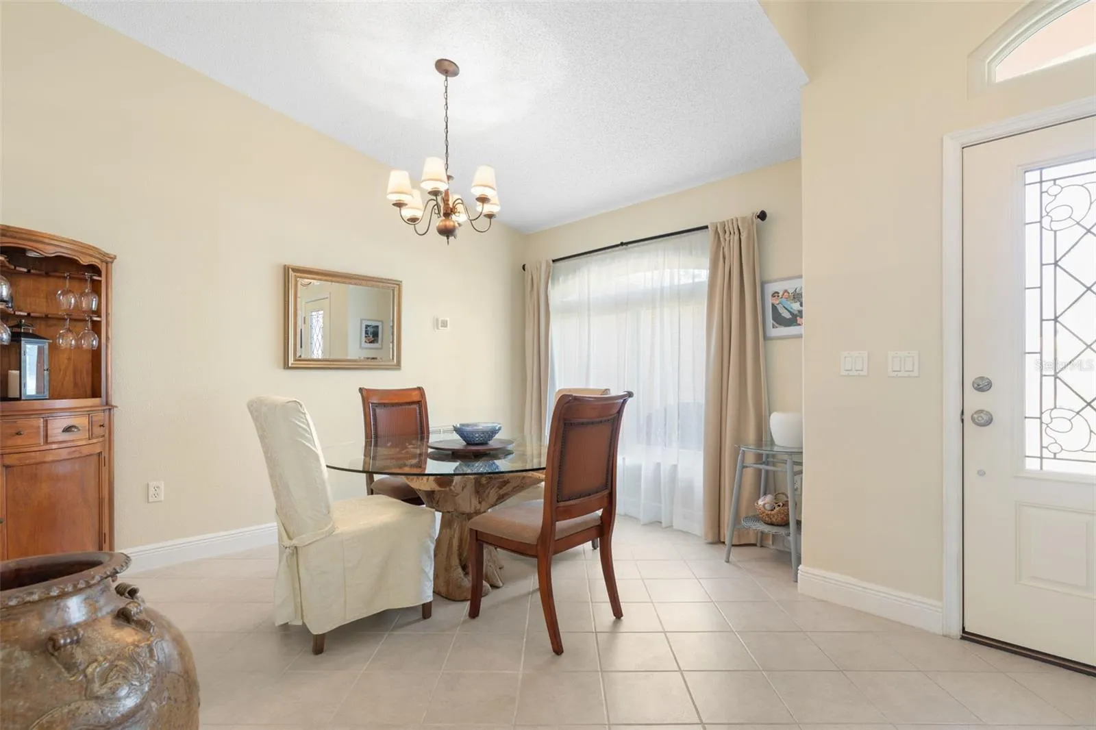 Set the table for memorable dinner parties and holiday celebrations! This charming formal dining room offers an intimate setting, with soft natural light and an elegant chandelier adding a touch of sophistication to every occasion.