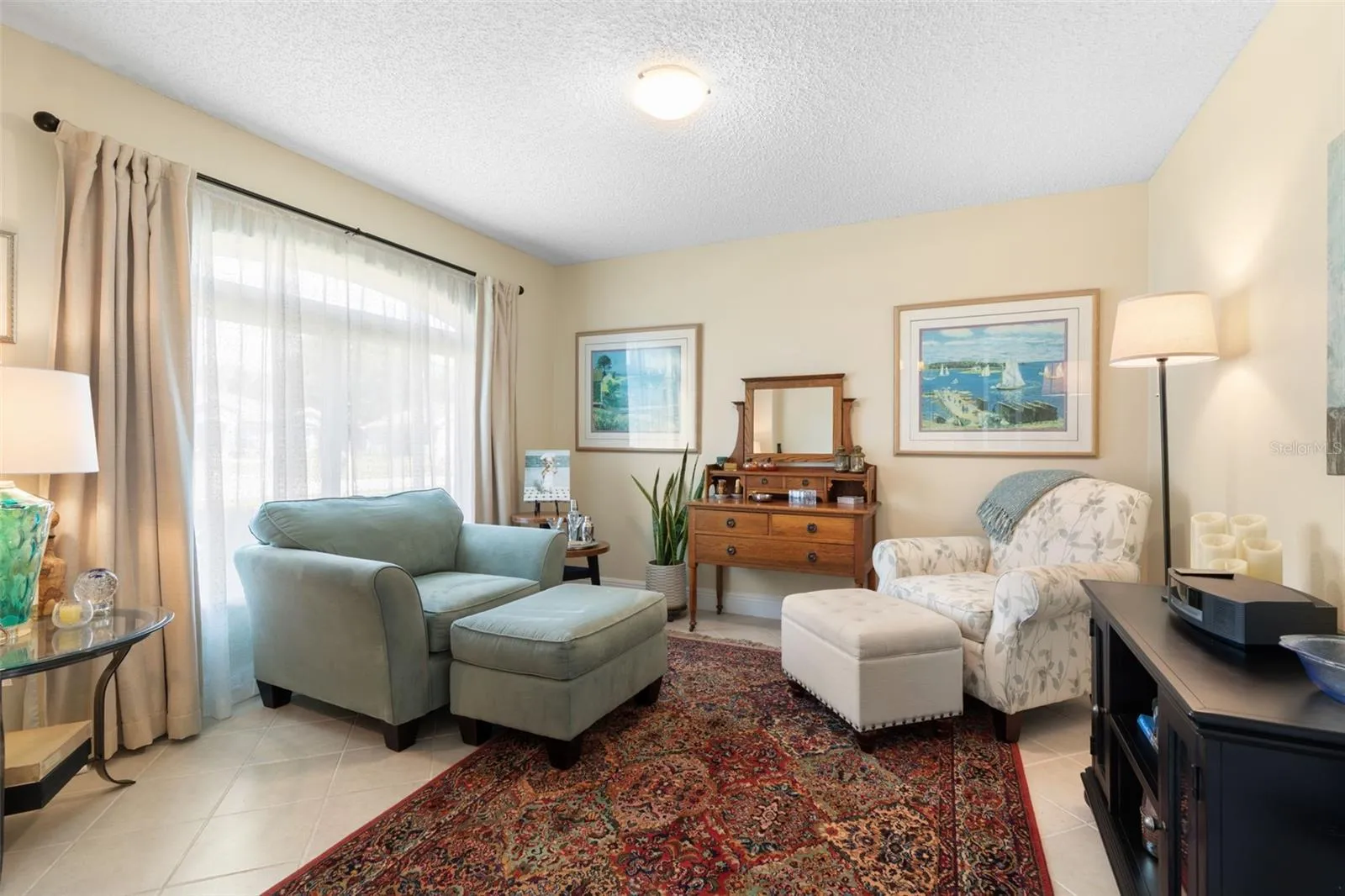 A room with endless possibilities! Currently styled as a sitting room, this flexible space can easily become your dream home office, personal library, creative studio, or a special place to call your own.