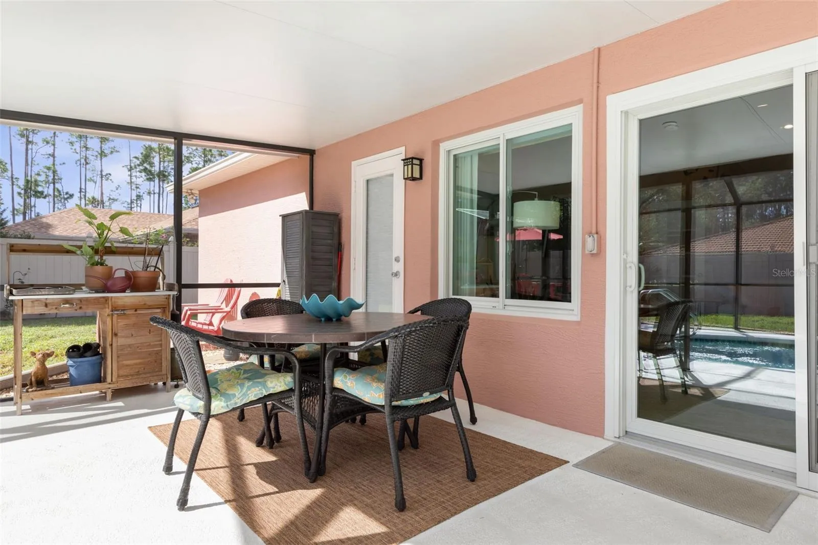 The covered patio offers a shady escape from the Florida sun, with convenient access to the screened pool just steps away. Whether enjoying the outdoors or taking a refreshing dip, relaxation is always within reach!