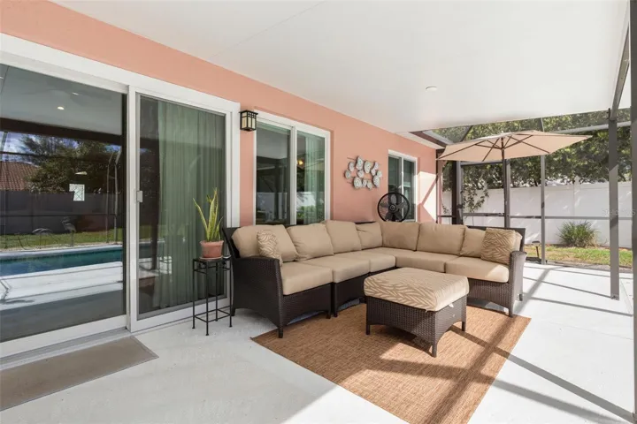 Stretching along the rear of the home, the expansive covered patio provides an exceptional extension of your living space, with ample room to create your own outdoor oasis while enjoying the beauty of Florida's year-round climate.