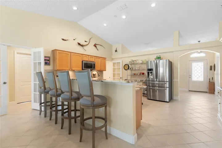 The extended granite breakfast bar offers seating for four, creating a stylish alternative to traditional dining with plenty of counter space for everything from a leisurely brunch to an evening appetizer spread.