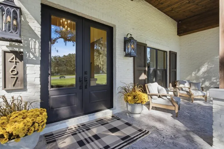 Charming covered porch ... Love this custom double door entrance!