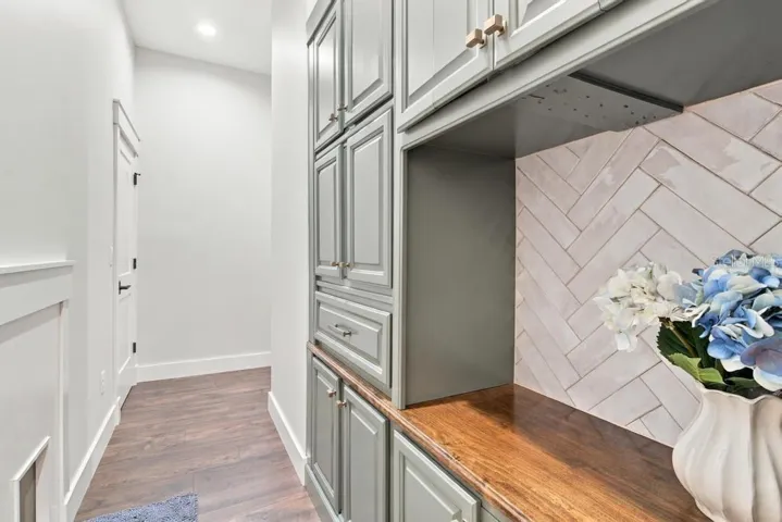Another entry to laundry room with additional custom cabinetry and walk-in closet