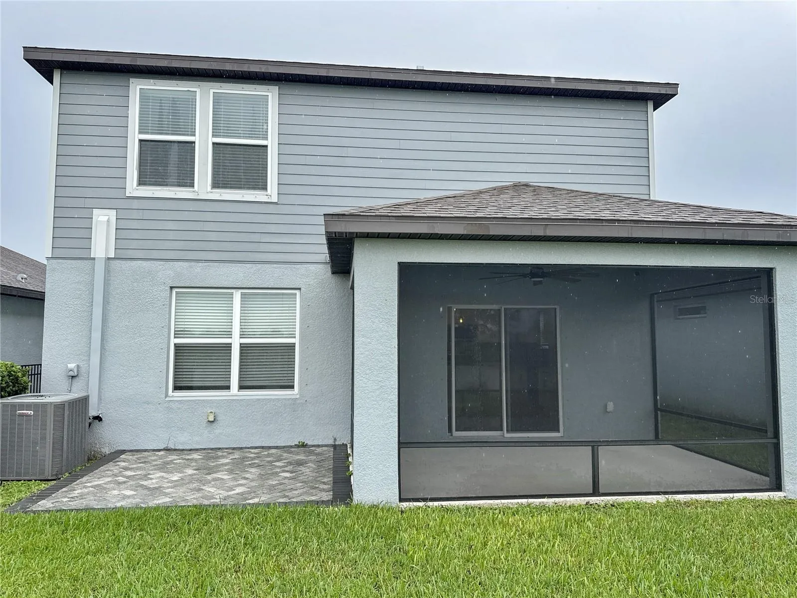 exterior back view of home showing covered and screened lanai