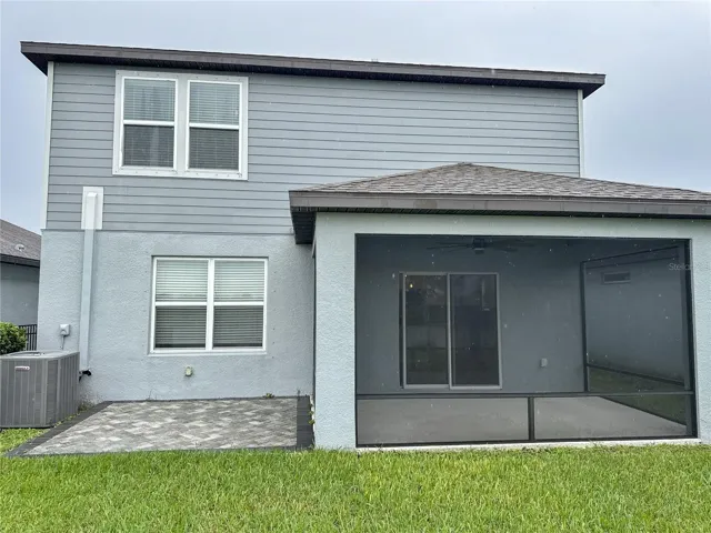 exterior back view of home showing covered and screened lanai