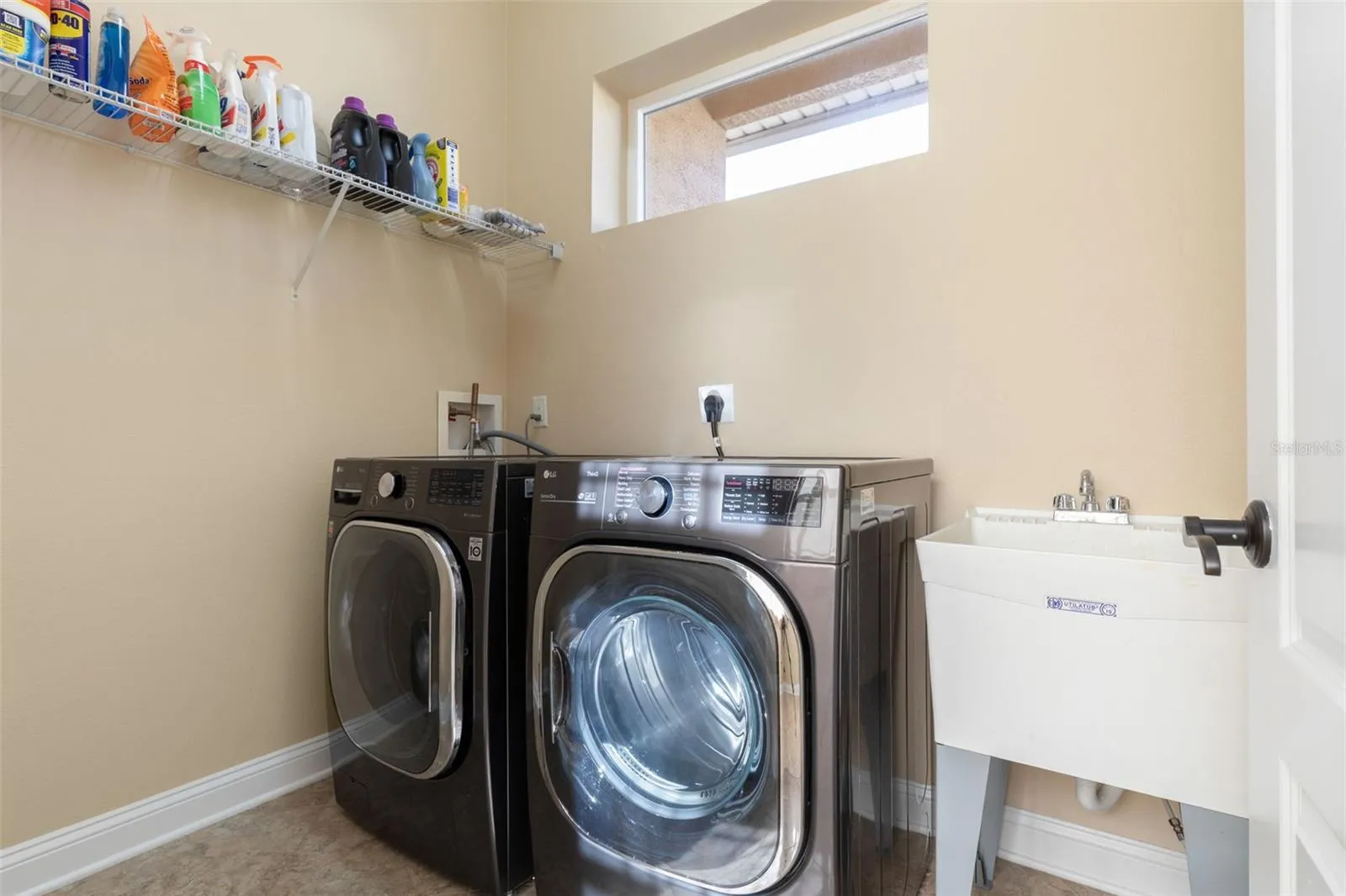 Convenient Indoor Laundry Room with Washer, Dryer &amp; Utility Sink