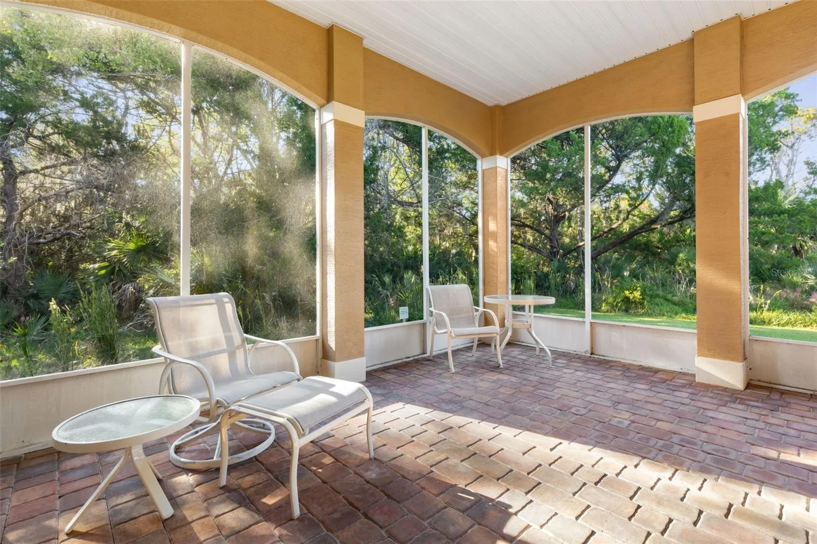 Relaxed indoor–outdoor living on the spacious screened lanai with peaceful conservation views.