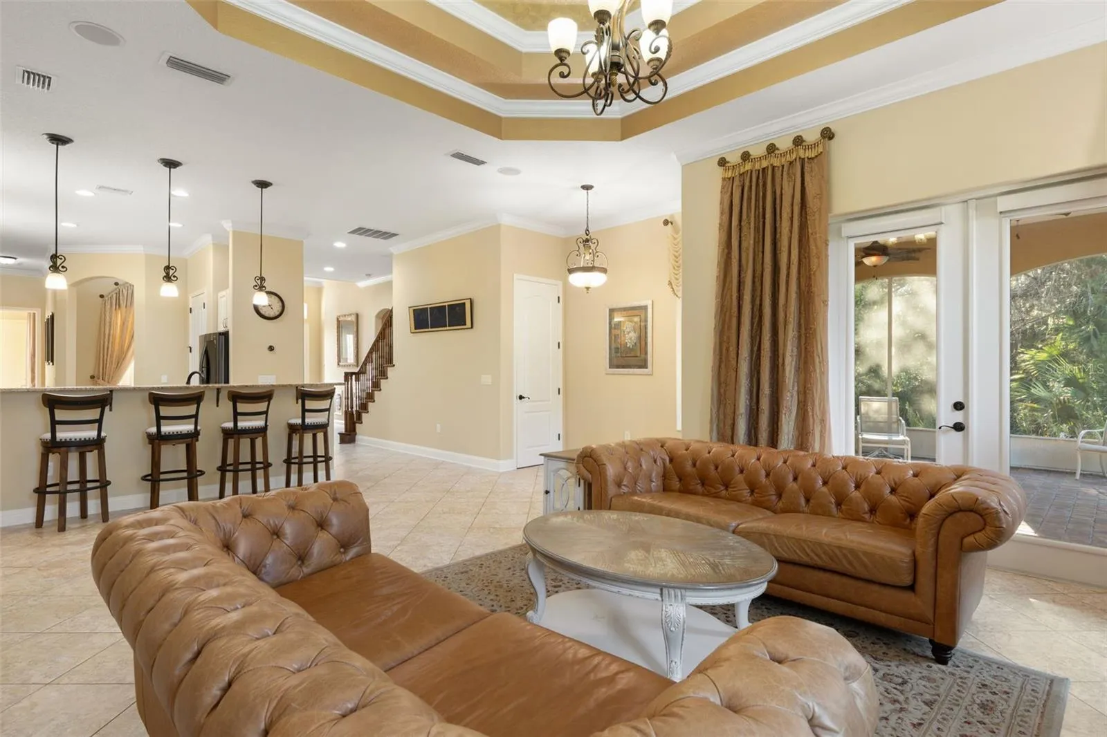 French doors open to the screened lanai, while the adjoining kitchen and breakfast bar create a natural flow for everyday living and entertaining.