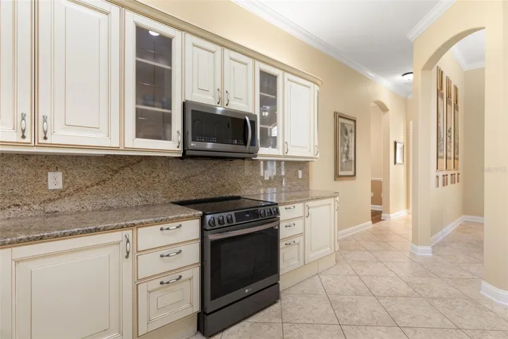 Beautifully detailed cabinetry, glass-front accents and graceful archways add character and architectural charm.
