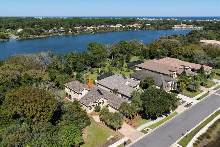 A sweeping aerial view showcases Emerald Lake behind the property, surrounded by lush natural greenery.