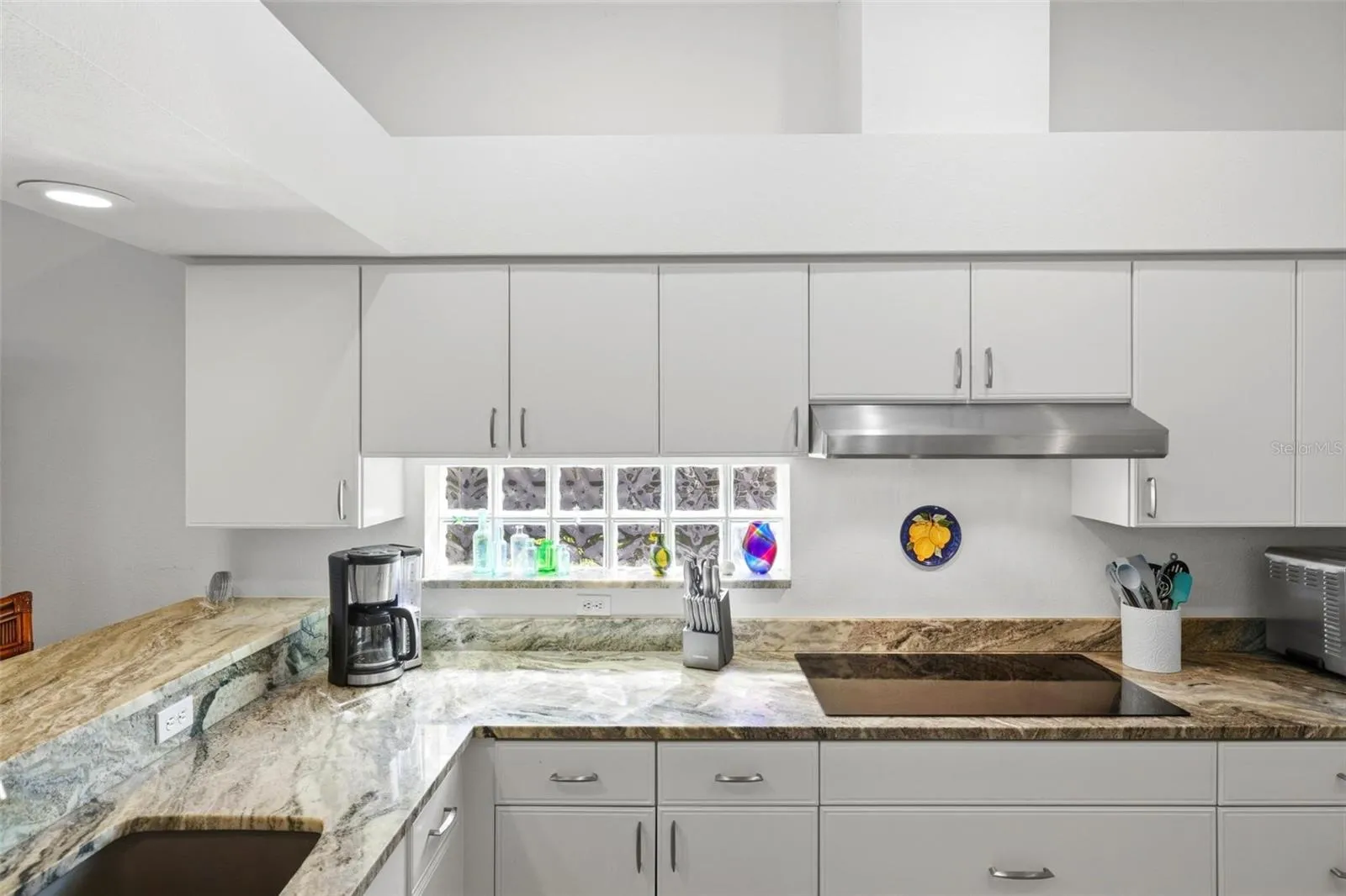 Kitchen with granite counters, glass cooktop